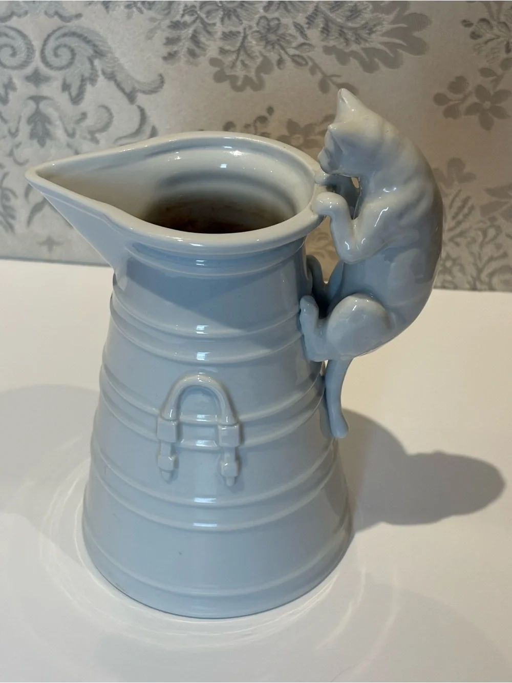 Vintage White Porcelain pitcher with a cat as a handle. Holds 20oz.